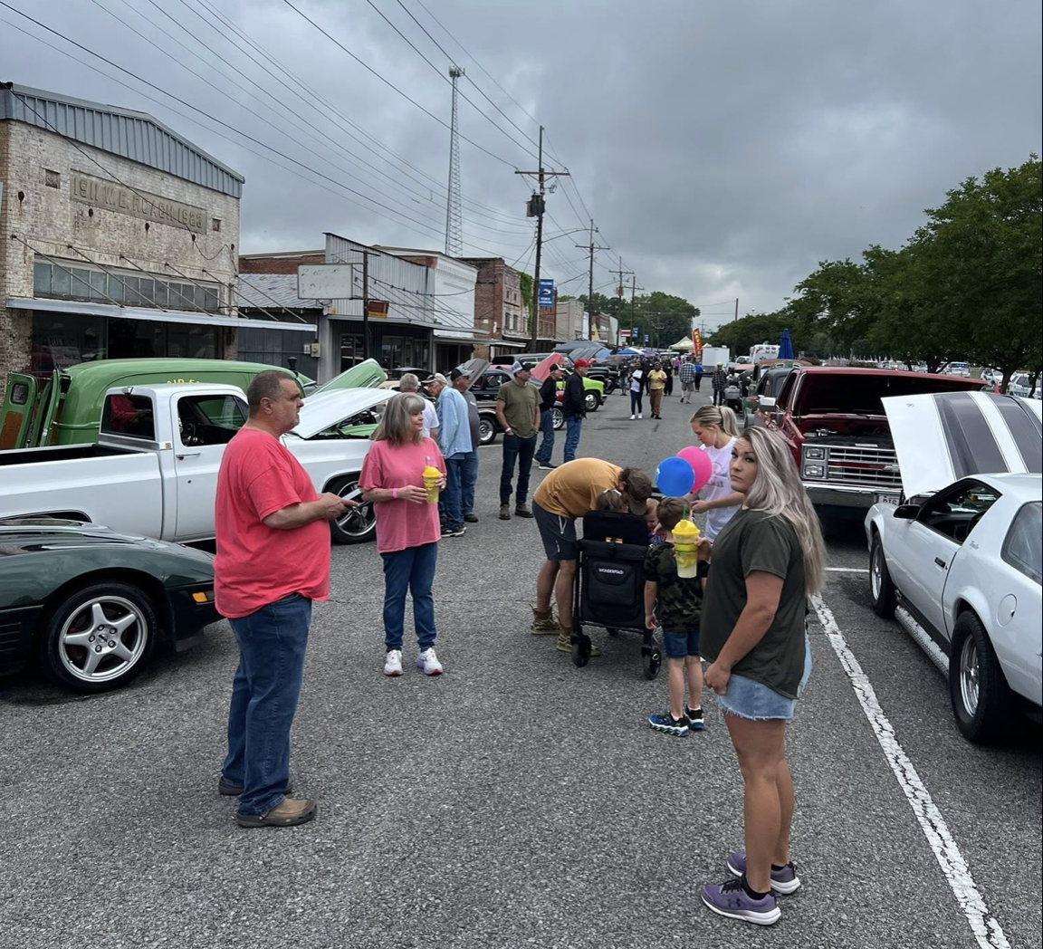 Families browsing the classic car show on Main Street